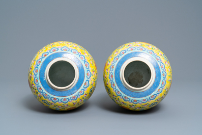 A pair of Chinese yellow-ground famille rose 'bats and shou' jars, Qianlong mark, 19th C.