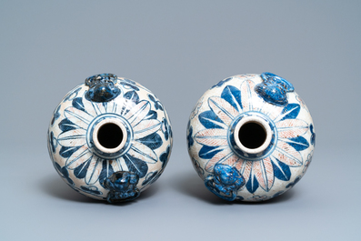 A pair of Chinese blue, white and copper-red meiping crackle-glazed vases, 19th C.