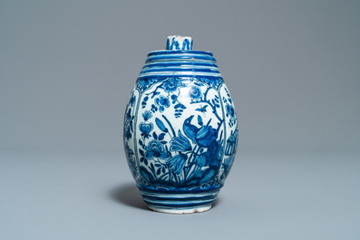 A Dutch Delft blue and white barrel-shaped gin flask with chinoiserie design, dated 1711