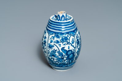 A Dutch Delft blue and white barrel-shaped gin flask with chinoiserie design, dated 1711