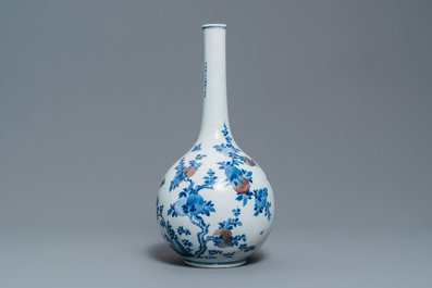 A Chinese blue, white and copper-red 'peaches' bottle vase with inscription, Kangxi