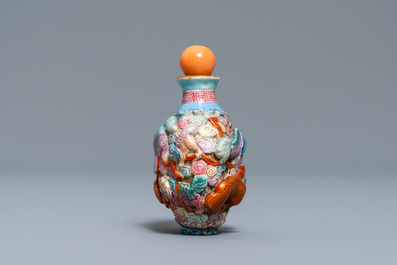 A Chinese famille rose moulded 'Buddhist lions' snuff bottle, Qianlong mark, 19th C.