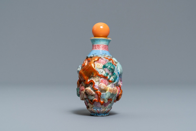 A Chinese famille rose moulded 'Buddhist lions' snuff bottle, Qianlong mark, 19th C.