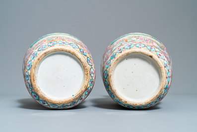 A pair of Chinese Canton famille rose pink-ground vases, 19th C.