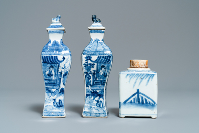 A pair of square Chinese blue and white covered vases and a tea caddy, Kangxi