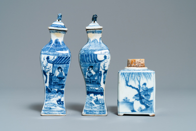 A pair of square Chinese blue and white covered vases and a tea caddy, Kangxi