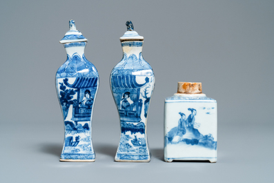 A pair of square Chinese blue and white covered vases and a tea caddy, Kangxi