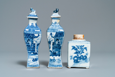 A pair of square Chinese blue and white covered vases and a tea caddy, Kangxi