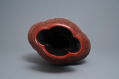 A Chinese carved cinnabar lacquer vase, Qianlong mark, 19/20th C.
