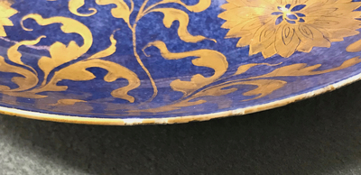 A Chinese powder blue and gilt dish with floral design, Kangxi