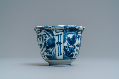 A Chinese blue and white kraak porcelain charger, a vase, a crow cup and a small plate, Wanli