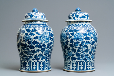 A pair of Chinese blue and white vases and covers with phoenixes, 19th C.