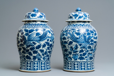 A pair of Chinese blue and white vases and covers with phoenixes, 19th C.