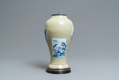 A Chinese blue and white on carved celadon-glazed ground vase, Kangxi