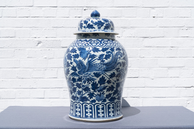 A pair of Chinese blue and white vases and covers with phoenixes, 19th C.