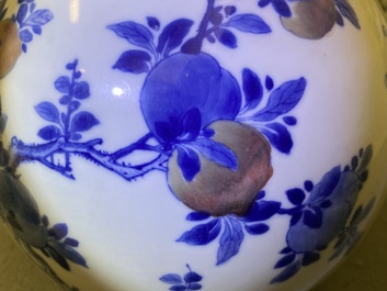 A Chinese blue, white and copper-red 'peaches' bottle vase with inscription, Kangxi