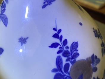 A Chinese blue, white and copper-red 'peaches' bottle vase with inscription, Kangxi