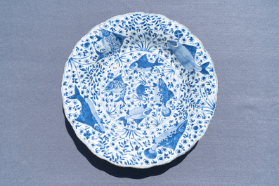 A large Chinese blue and white lobed dish with fish, Kangxi