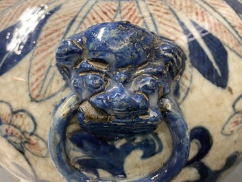 A pair of Chinese blue, white and copper-red meiping crackle-glazed vases, 19th C.