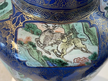 A massive Chinese famille verte on powder blue-ground rouleau vase, Kangxi