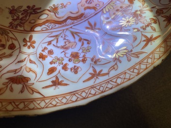 Three Chinese iron-red and gilt plates and a silver-mounted dish, Kangxi