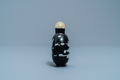 A Chinese black-ground grisaille and iron red vase and a snuff bottle, 18th C.