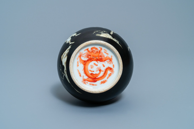 A Chinese black-ground grisaille and iron red vase and a snuff bottle, 18th C.