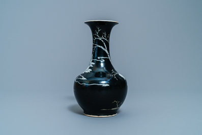 A Chinese black-ground grisaille and iron red vase and a snuff bottle, 18th C.