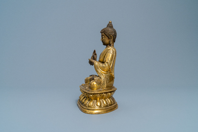 A Chinese gilt bronze figure of Buddha, 17th C.