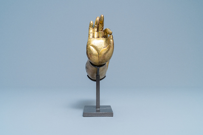 A Tibetan gilt bronze and copper alloy arm of Buddha, Ming