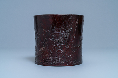 A Chinese carved zitan wood brush pot with a mountainous landscape, 17/18th C.