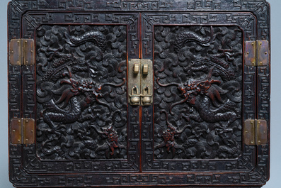 Un petit cabinet en bois sculpt&eacute; &agrave; d&eacute;cor de dragons, Chine, R&eacute;publique