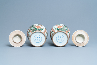 A pair of Chinese famille verte vases and covers, Kangxi mark, 19th C.