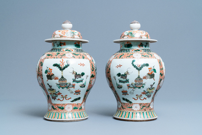 A pair of Chinese famille verte vases and covers, Kangxi mark, 19th C.