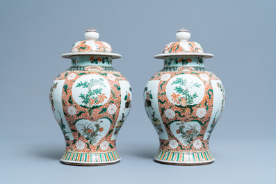 A pair of Chinese famille verte vases and covers, Kangxi mark, 19th C.