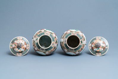 A pair of Chinese famille verte vases and covers, Kangxi mark, 19th C.