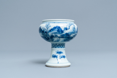 A Chinese blue and white stem cup with a continuous landscape scene, Kangxi/Yongzheng