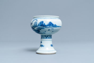 A Chinese blue and white stem cup with a continuous landscape scene, Kangxi/Yongzheng