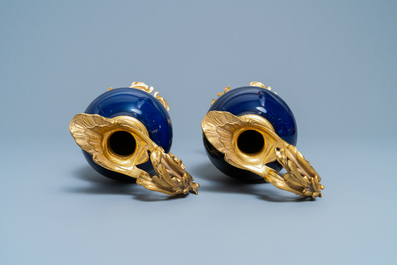 A pair of Chinese gilt bronze ewer-mounted monochrome blue vases, 18/19th C.