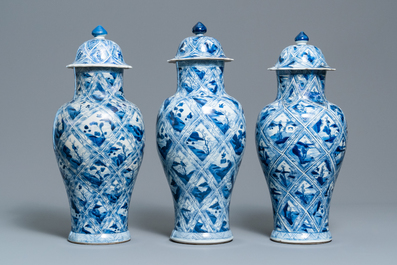 A large Chinese blue and white five-piece garniture with floral and landscape panels, Kangxi