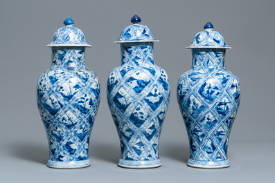 A large Chinese blue and white five-piece garniture with floral and landscape panels, Kangxi