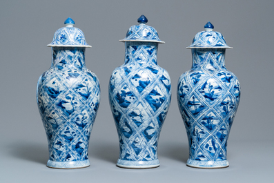 A large Chinese blue and white five-piece garniture with floral and landscape panels, Kangxi
