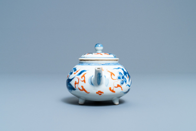A rare Chinese blue, white, iron red and gilt tripod teapot and cover, Kangxi