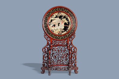 A massive Chinese carved wooden screen with a round famille verte plaque and polychrome lacquer, 19th C.