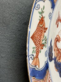 A Chinese famille verte dish with a carp surrounded by horses and Buddhist lions, Kangxi