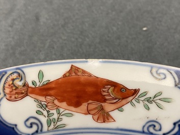 A Chinese famille verte dish with a carp surrounded by horses and Buddhist lions, Kangxi