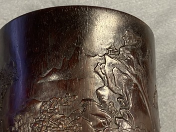 A Chinese carved zitan wood brush pot with a mountainous landscape, 17/18th C.