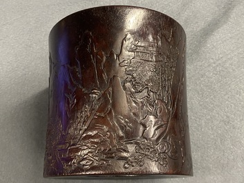 A Chinese carved zitan wood brush pot with a mountainous landscape, 17/18th C.