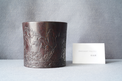 A Chinese carved zitan wood brush pot with a mountainous landscape, 17/18th C.