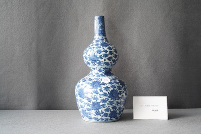 A Chinese blue and white 'lotus scroll' double gourd vase, Wanli